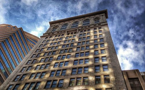 Low angle view of building against cloudy sky