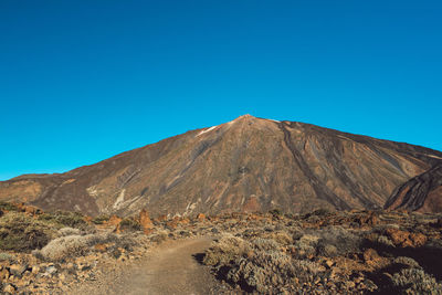 View of volcanic mountain against blue sky