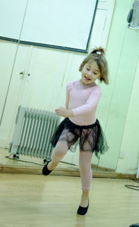 Full length portrait of young woman jumping