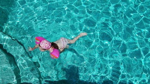 High angle view of girl swimming in pool