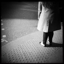 Low section of woman standing on tiled floor