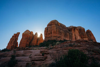 Low angle view of rock formations against sky