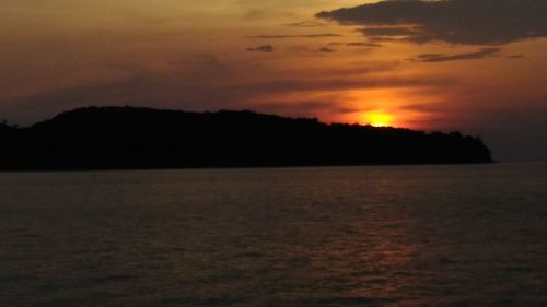 Scenic view of sea against orange sky