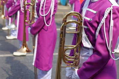 Midsection of marching band on street