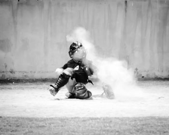 Boy playing baseball on playing field