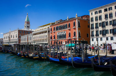 Boats in canal against buildings in city