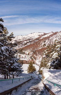 Scenic view of snow covered mountains against sky