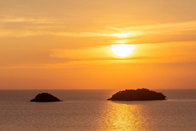 Scenic view of sea against romantic sky at sunset