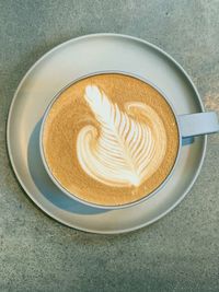 Directly above shot of cappuccino served on table