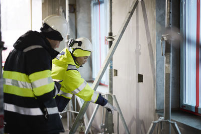 Male and female engineer working at construction site