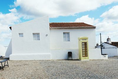 Houses against cloudy sky