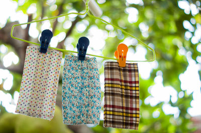 Low angle view of clothespins hanging on clothesline