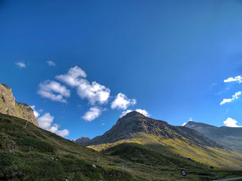 Scenic view of mountains against blue sky