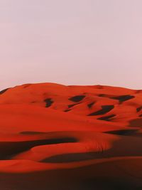 Sand dunes in desert against clear sky