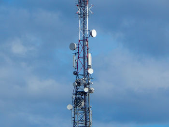 Low angle view of communications tower against sky