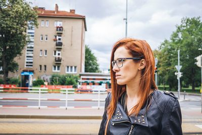 Portrait of young woman looking away outdoors