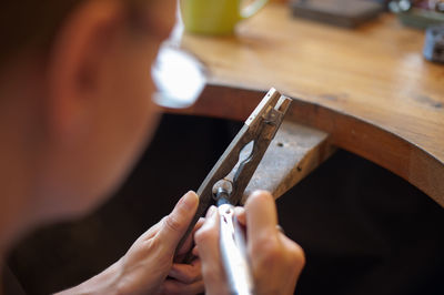 Close-up of goldsmith working on ring