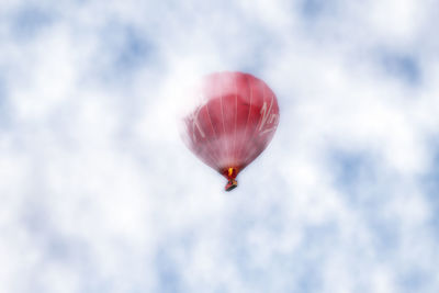 Low angle view of balloon flying against sky