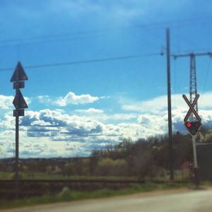 Street light against cloudy sky