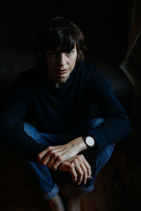 Portrait of young man sitting at home