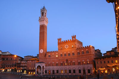 Low angle view of illuminated building against sky