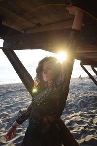 Portrait of young woman standing at beach