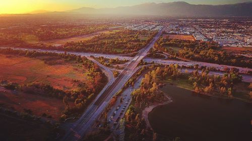 Aerial view of multiple lane highway on landscape during sunset