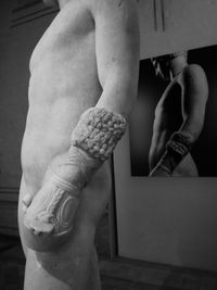 Low section of woman with statue