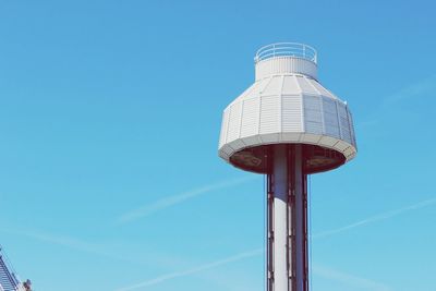 Low angle view of water tower against blue sky