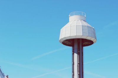 Low angle view of water tower against clear blue sky