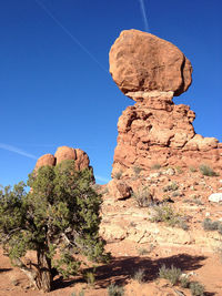 Low angle view of rocks against blue sky