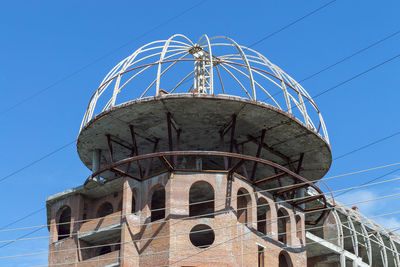 Low angle view of roof building against blue sky