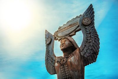 Low angle view of statue against sky