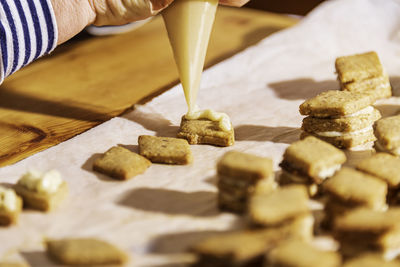 Close-up of person preparing food on table