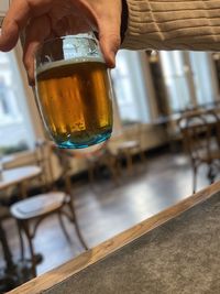 Close-up of hand holding glass of drink