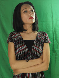 Portrait of beautiful woman standing against wall