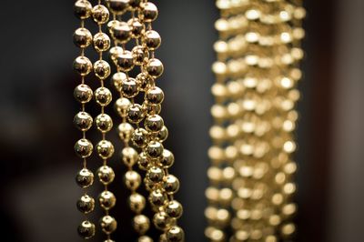 Close-up of golden necklace hanging at market