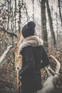 Rear view of couple standing in forest