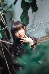 Portrait of young woman standing outdoors