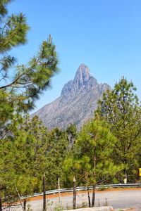 Scenic view of mountains against clear blue sky