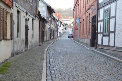 Empty alley amidst buildings in city