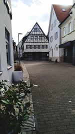 Empty alley amidst buildings in city