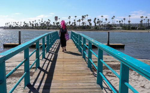 Rear view of woman on pier