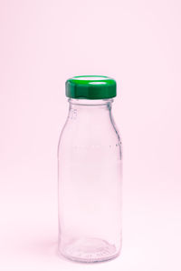 Close-up of green bottle against white background