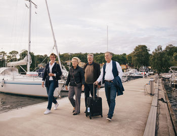 People on boat against sky