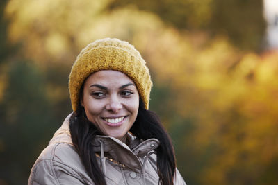 Portrait of smiling young woman standing outdoors