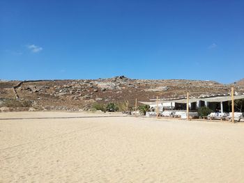 Scenic view of desert against blue sky