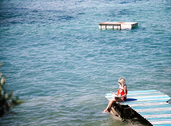 Woman sitting in sea