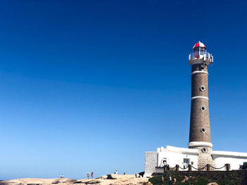 Low angle view of lighthouse against blue sky