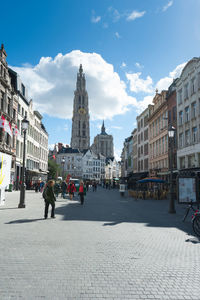 People on street amidst buildings in city